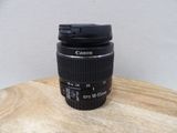 a camera lens on a wooden table with a white background