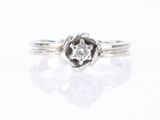a close up of a white gold and diamond ring on a white background