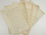 a bunch of old letters sitting on top of a white table