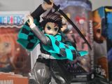 a figurine of a woman with a sword in a display case