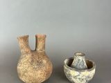 two vases sitting next to each other on a table