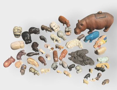 a lot of small figurines of animals on a white surface