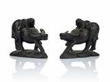 two figurines of animals that are sitting on top of each other