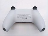 a close up of a wii controller on a white surface