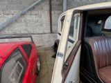 a red car and a white car in a garage