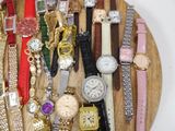a wooden plate with many different watches on it
