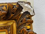 a picture of a gold frame with a white flower on it