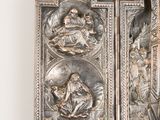 a metal panel with a religious scene on it
