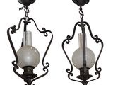 pair of art nouveau style sconces with white glass shades