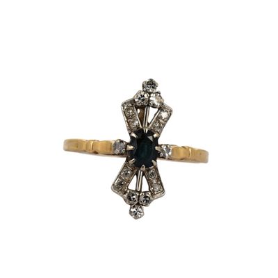 gros plan d'une bague en or avec une pierre bleue