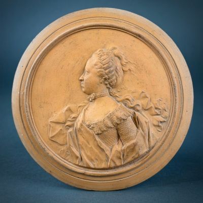 an image of a carved plaque of a woman