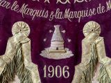 a purple banner with gold fringes hanging on a wall