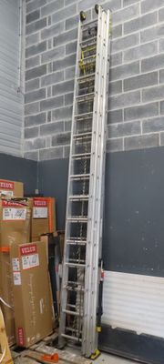 a ladder that is next to some boxes in a room