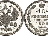 a silver coin with the image of a bird and a crown on it