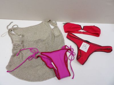 two bikinis and a hat on a white table