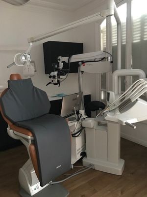 a dentist ' s chair in the corner of the room