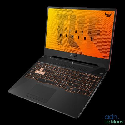 the laptop is open on a black surface with a red keyboard
