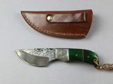 two different types of knives on a white surface