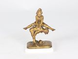 bronze figurine of a man on a skateboard on a marble base