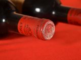 two bottles of wine sitting next to each other on a table