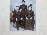 a black and white photo of a family posing for a picture