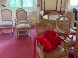 a room with a lot of chairs and a table in it