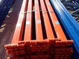 a long red bench sitting in the middle of a warehouse