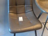 pair of black leather bar stools with metal legs