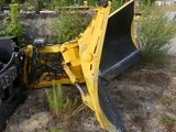 a yellow bulldozer sitting in the middle of a field