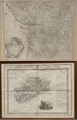 two maps on display on the wall of a room
