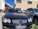 cars parked in a parking lot in front of a building