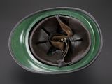 a close up of a helmet with a green rim