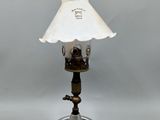 a lamp that is sitting on a table with a white shade