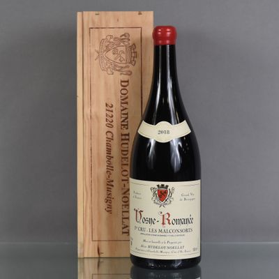 a bottle of wine sitting next to a wooden box