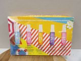 a box of three bottles of nail polish sitting on top of a wooden table