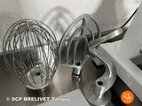 a silver mixer and a whisk on a kitchen counter
