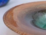 a close up of a bowl with a green liquid inside of it