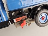 a toy truck that is attached to the back of a truck