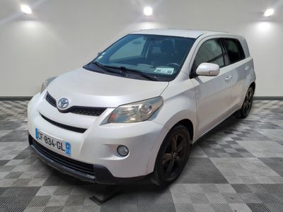 a picture of a white toyota yaris parked in a garage