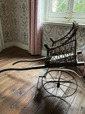 une poussette posée sur un plancher en bois