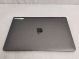 a black apple laptop sitting on a white surface