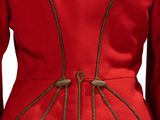 the back of a red jacket with gold buttons on it