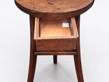 a small wooden table with a drawer underneath it