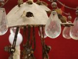 a close up of a chandelier hanging from a red wall