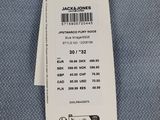 the label on the back of a jacket is attached to a hanger