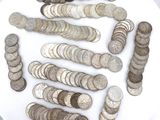 a lot of coins on a white plate on a table