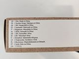someone is holding a box with a list of items in it