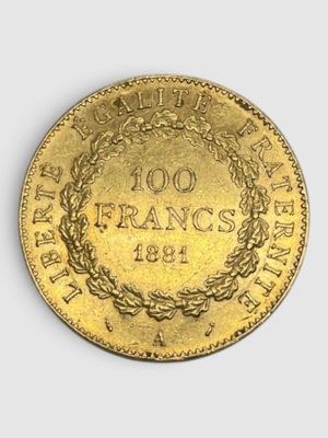 a close up of a gold coin with a wreath on it