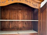 a wooden cabinet with a shelf and drawers in it