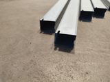 four pieces of steel are stacked on top of each other on the ground